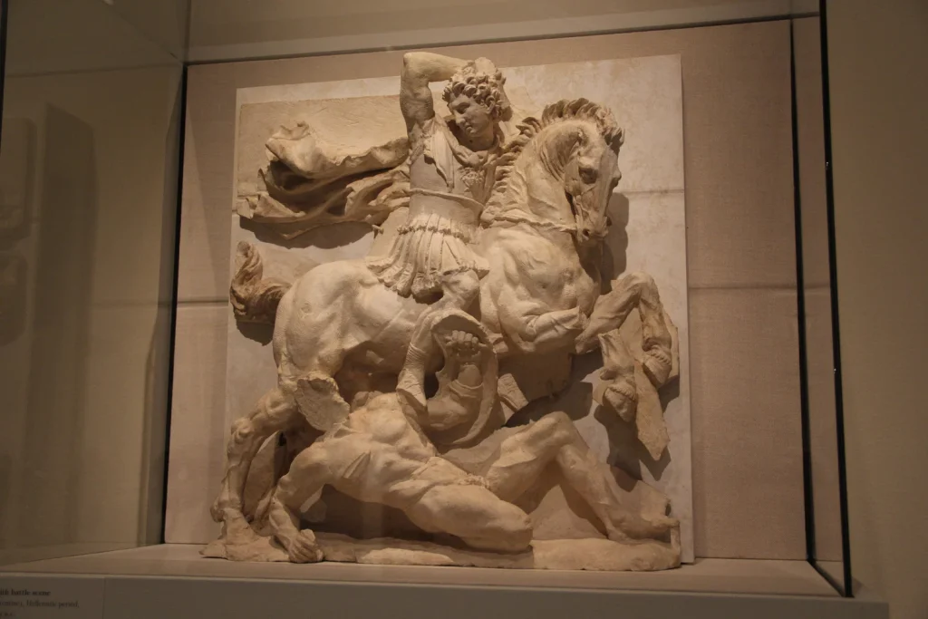 Gjetur në Varrin I, Via Umbria, Taranto, Itali. Kjo metope nga fundi i shekullit të 3-të deri në fillim të shekullit të 2-të p.e.s. dekoronte një varr të ngjashëm me tempullin sipas traditës së mbretërve maqedonas dhe duke huazuar figura nga përshkrimet e Aleksandrit të Madh. Kalorësi është identifikuar si Mbreti Pirro i Epirit.